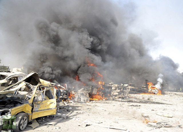 Smoke rises from the wreckage of mangled vehicles at the site of an explosion in Damascus May 10, 2012. (Reuters / Sana)