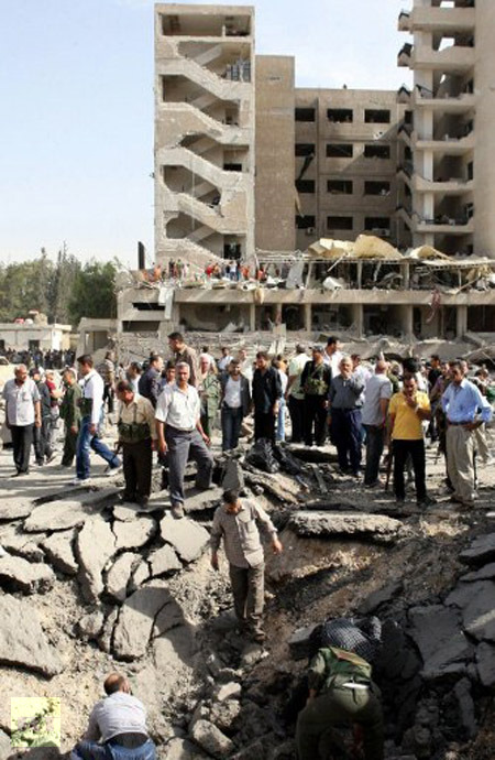 Syrians inspect a crate at the site of twin blasts in Damascus on May 10, 2012. (AFP Photo / Louai Beshara)